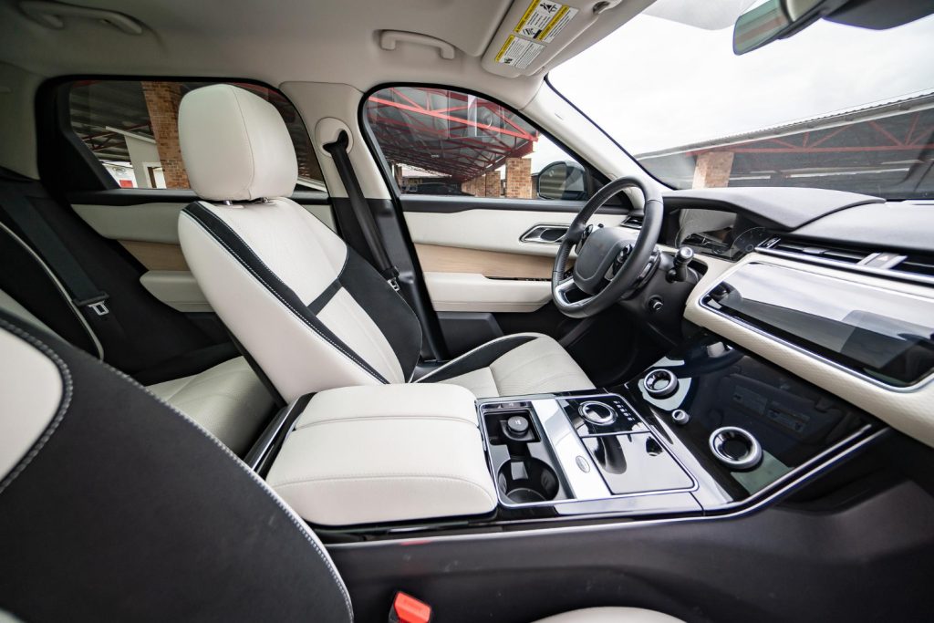 modern luxury prestige car interior dashboard steering wheel orange red perforated leather interior