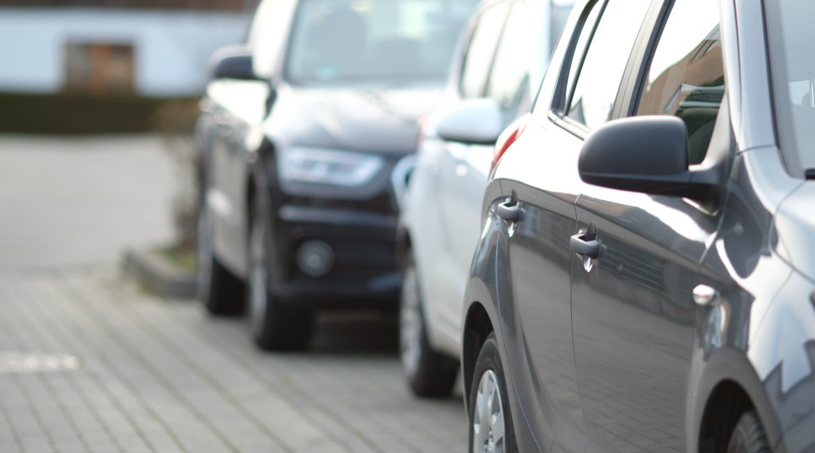 closeup shot black car parking lot with blurred background