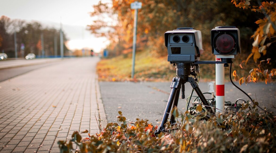 black and gray camera on tripod on road during daytime
